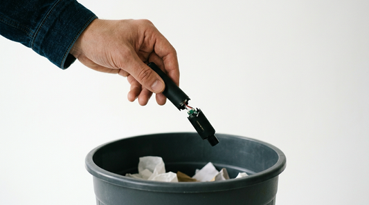 Hand dropping vape in trash — how to stop vaping